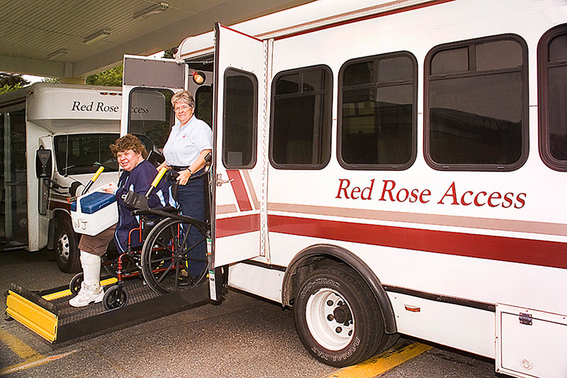 Red Rose Access bus driver assisting a handicap customer in a wheelchair
