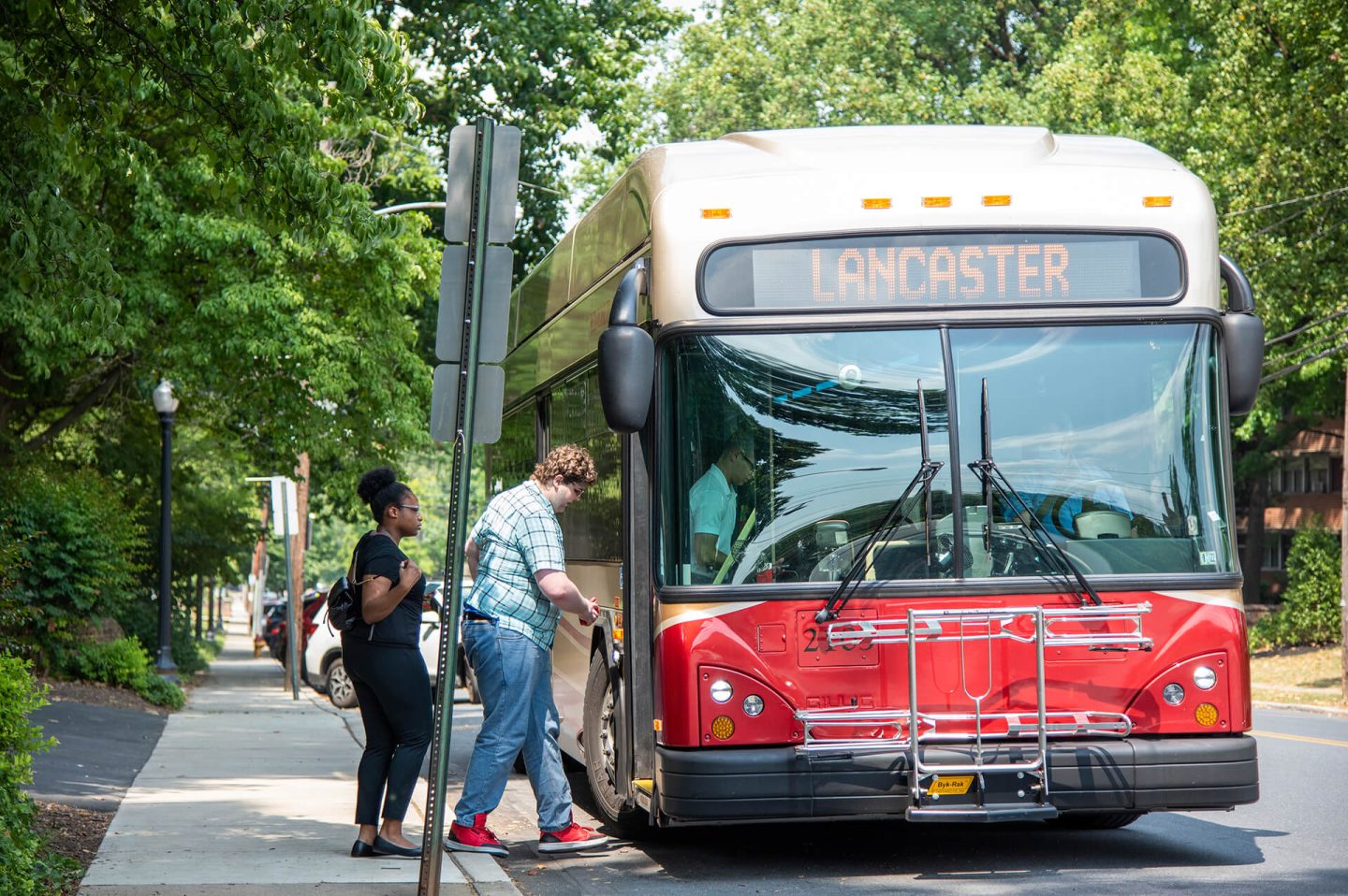 Customers loading onto a Red Rose Transit bus at bus stop