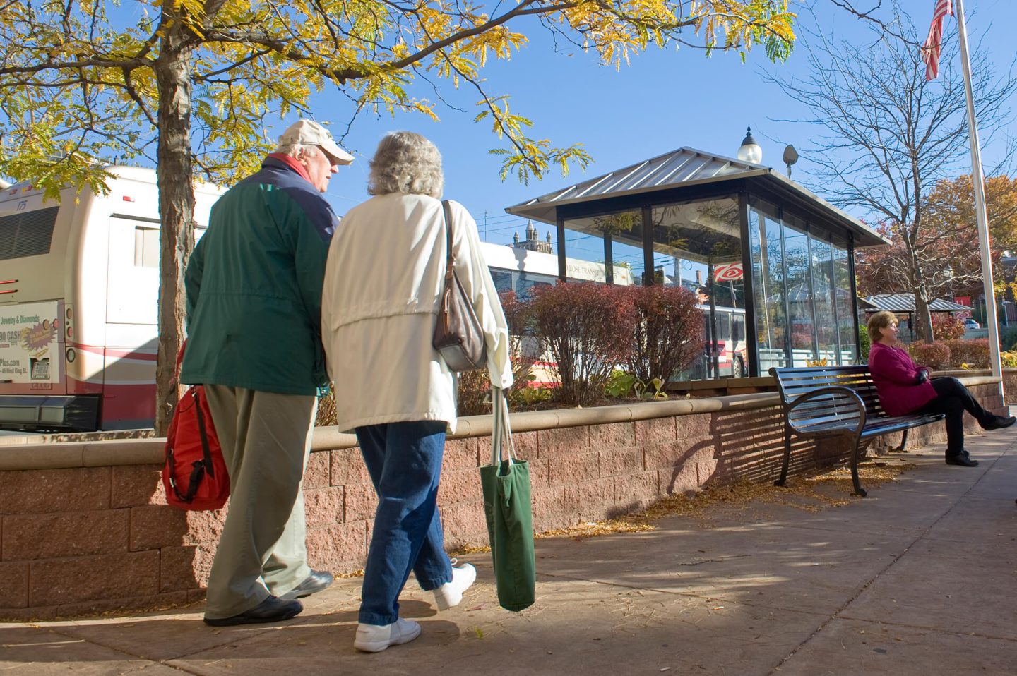 Elderly couple walking to a Red Rose Transit bus stop